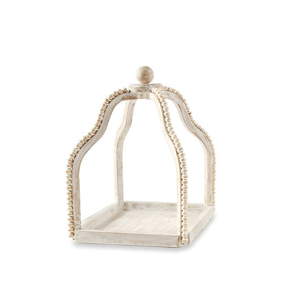 Decorative white wooden cloche with ornate design, featuring bead-like trim.