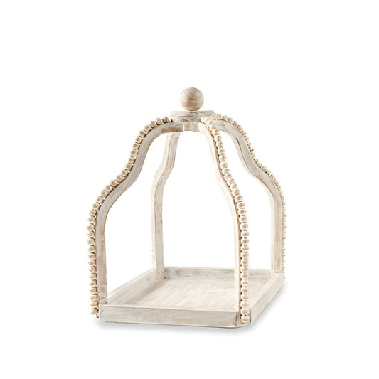 Decorative white wooden cloche with ornate design, featuring bead-like trim.