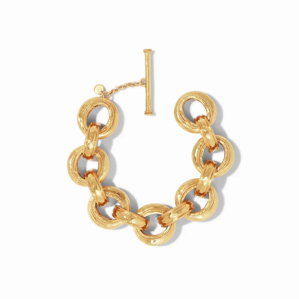A chunky gold chain bracelet with interlocking links and a toggle clasp.
