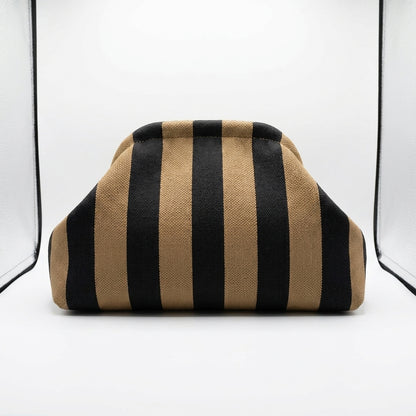 Striped brown and black fabric-covered object in a white setting.