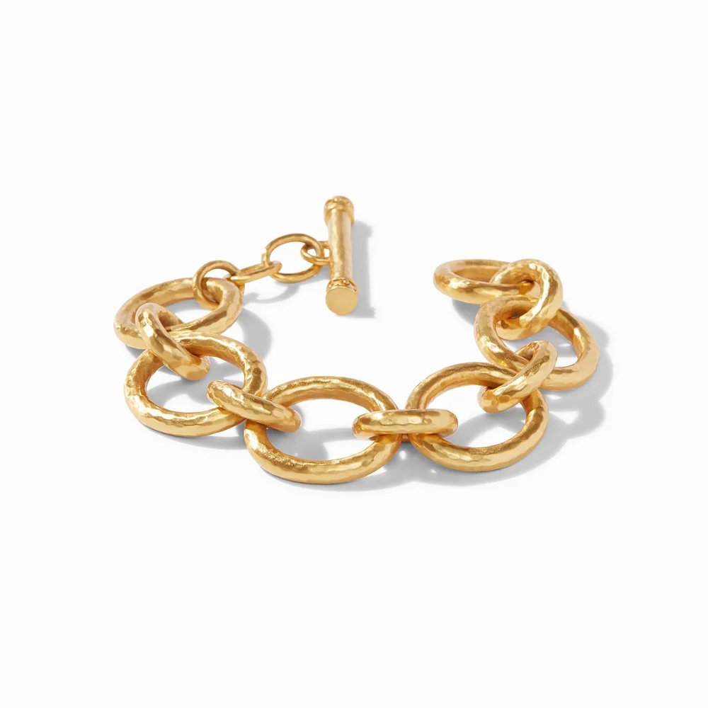 A chunky gold chain-link bracelet with a toggle clasp on a white background.