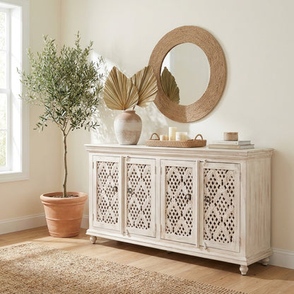 Ornate whitewashed sideboard with lattice doors and vintage knobs.