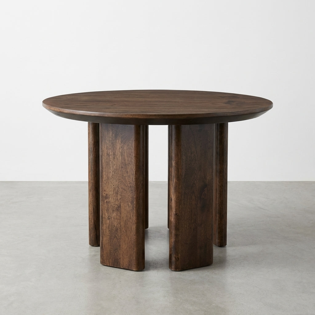 Round wooden table with unique block legs.
