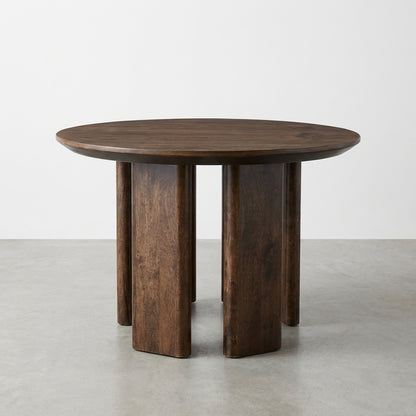 Round wooden table with unique block legs.