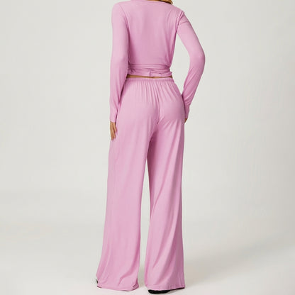 Person in pink lounge set, showing back view.