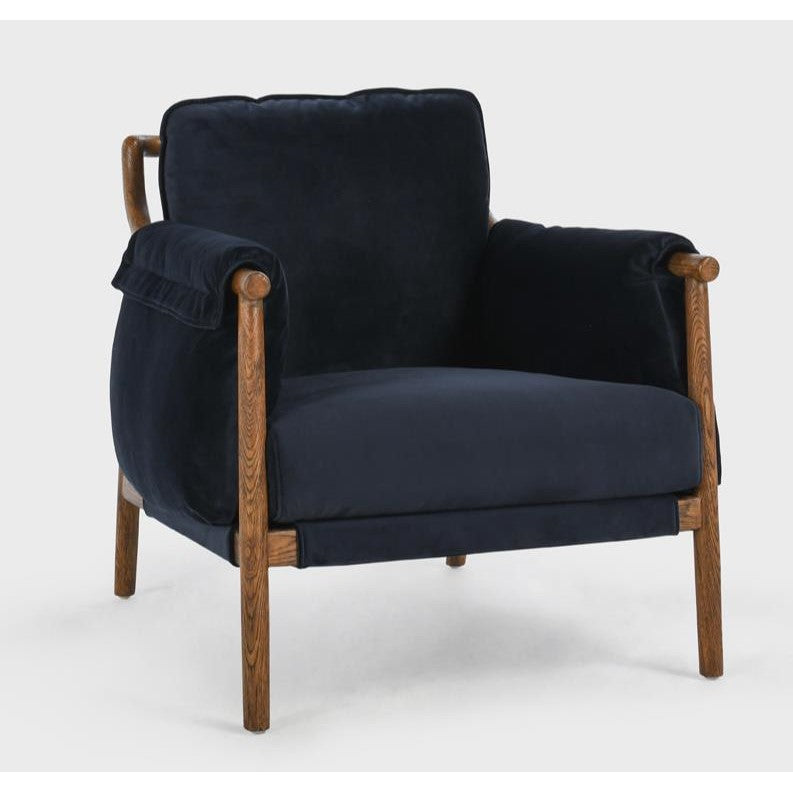 Navy velvet armchair with wooden frame and cushioned seat.