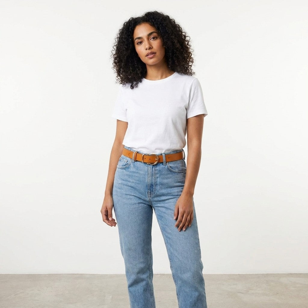 Person in white t-shirt and jeans standing on a plain background.