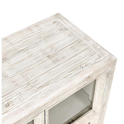 Whitewashed wooden cabinet with glass doors, viewed from above.
