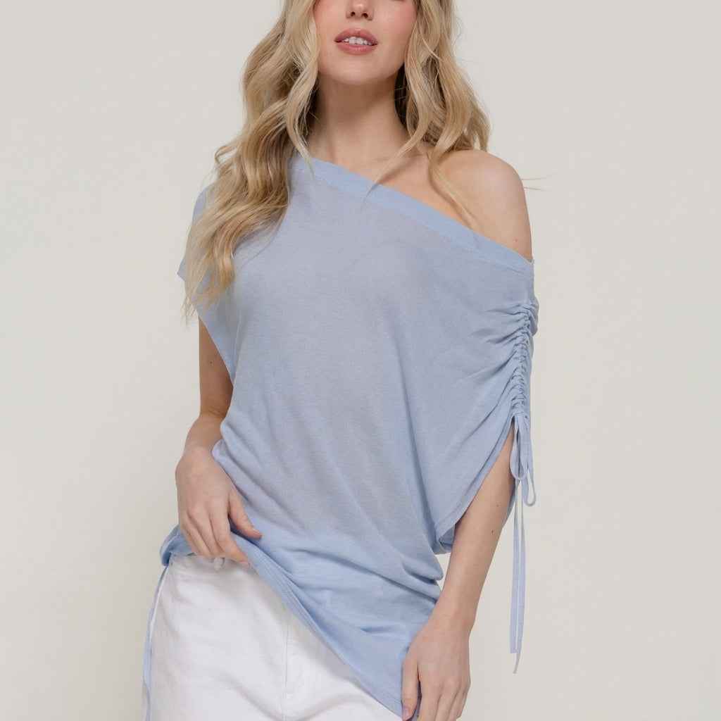 Person in a light blue top and white pants, with long blonde hair.