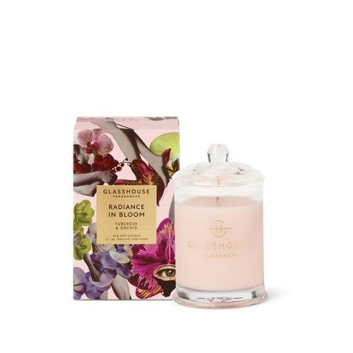 Glass candle with floral box, labeled "Radiance in Bloom" by Glasshouse Fragrances.