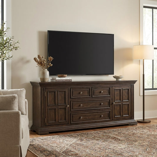 Living room with TV, wooden console, sofa, and lamp.
