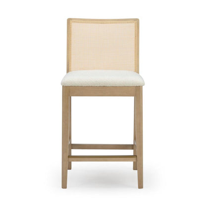 Wooden bar stool with a cushioned seat and woven backrest.