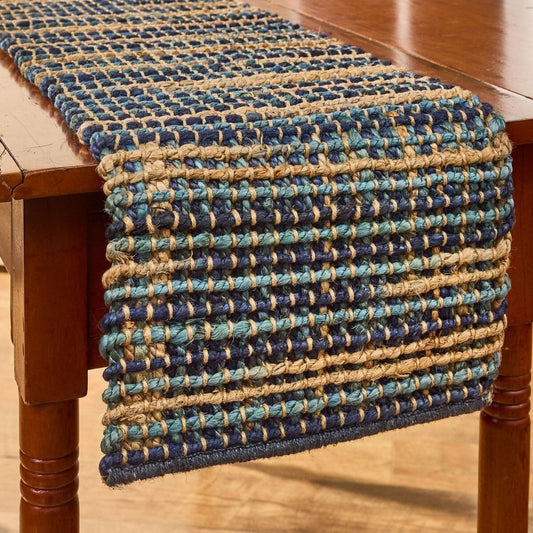 Woven table runner in blue and beige on a wooden table.