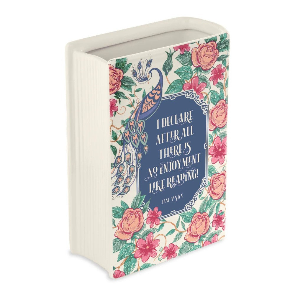 Decorative vase shaped like a book with floral and peacock designs.