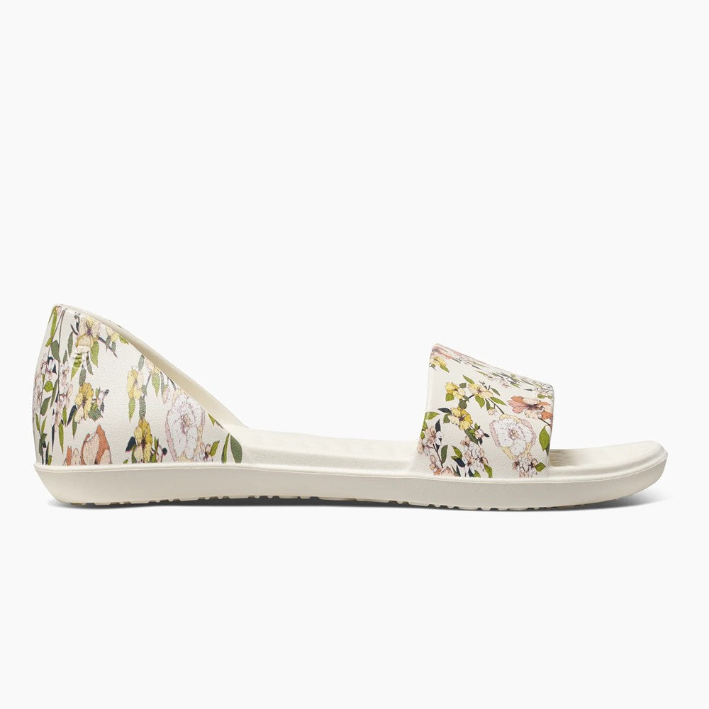 Floral-print sandal with open toe and back, featuring a flat sole.