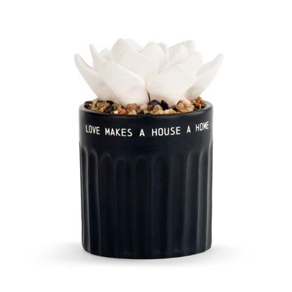 Black pot with white flower and text: "LOVE MAKES A HOUSE A HOME."