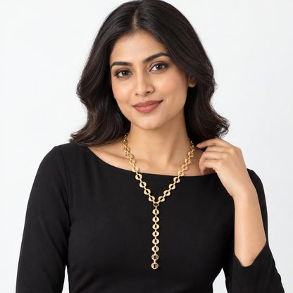 Woman in black dress wearing a gold necklace.