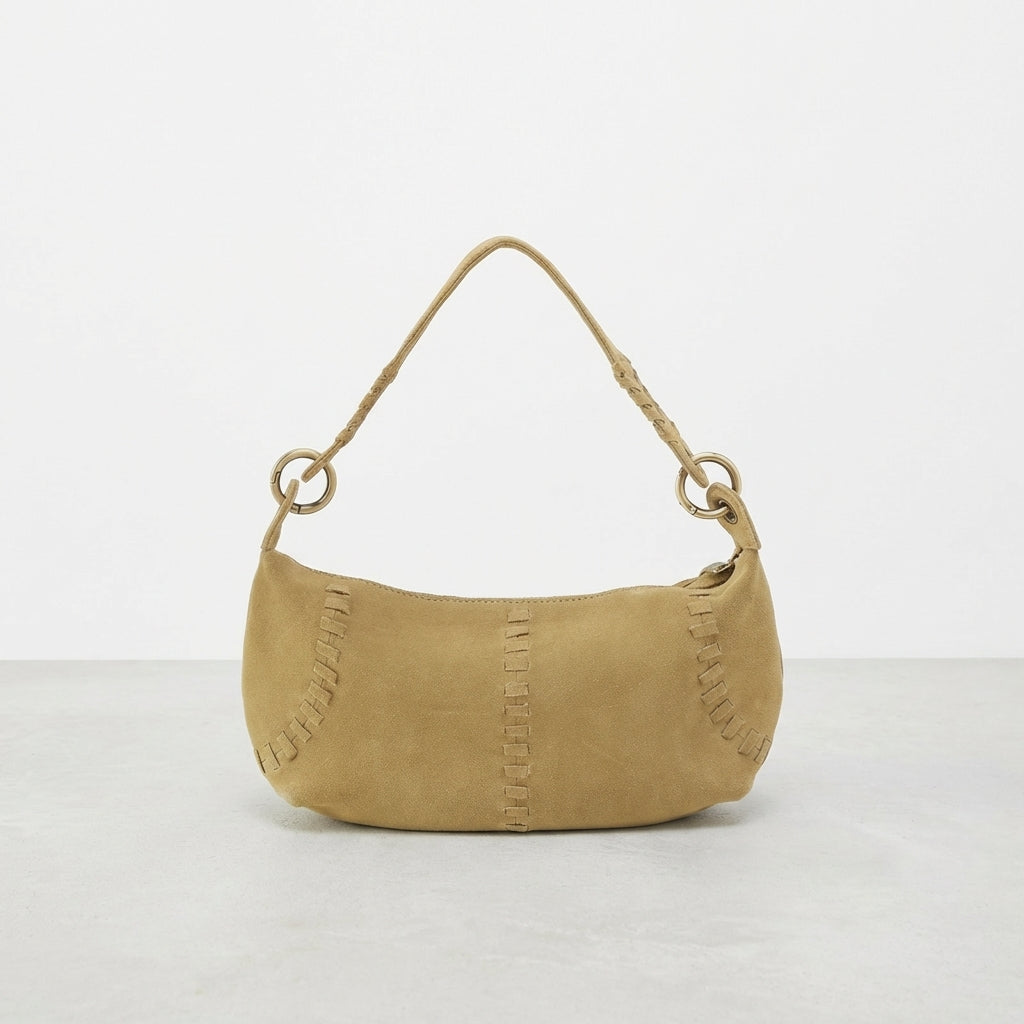 Small tan handbag with loop handle and decorative stitching.