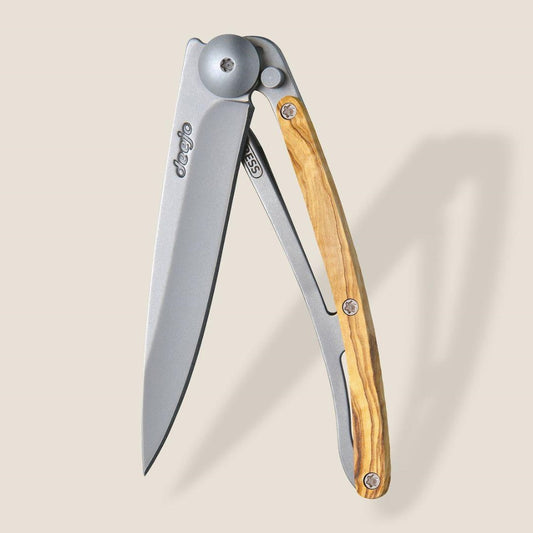 Folding knife with a wooden handle and a sleek silver blade.