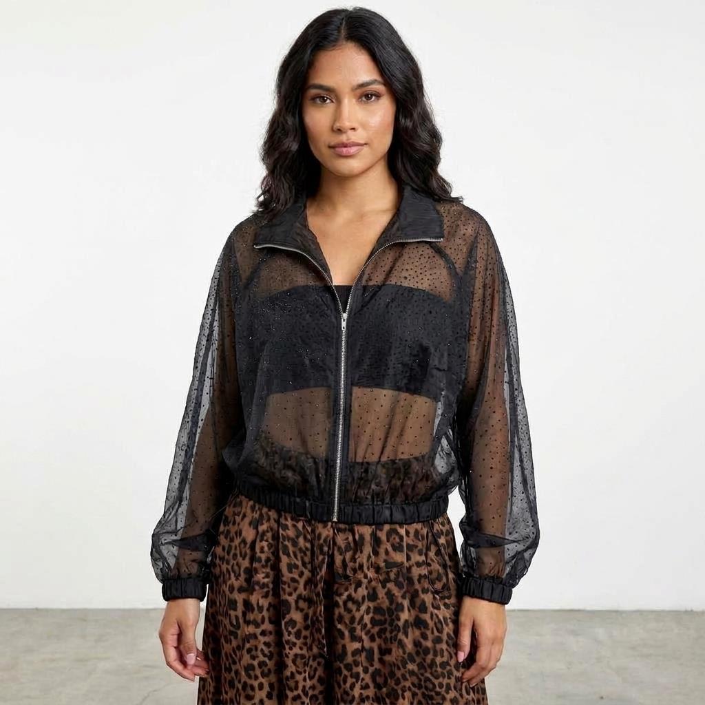 Woman in sheer black top with animal print skirt.