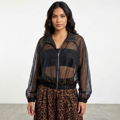 Woman in sheer black top with animal print skirt.