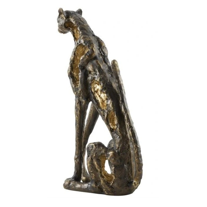 Bronze cheetah sculpture sitting, facing away.