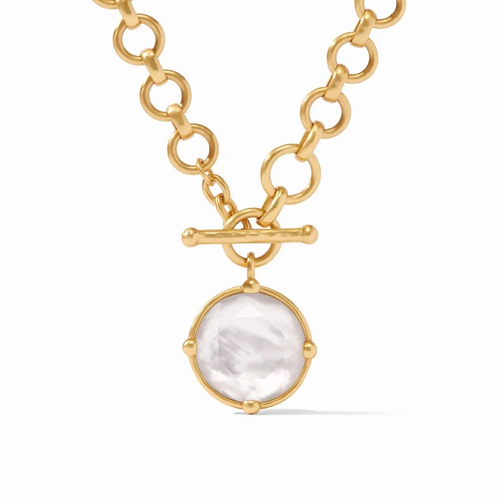 Gold chain necklace with a toggle clasp and a round white gemstone pendant.
