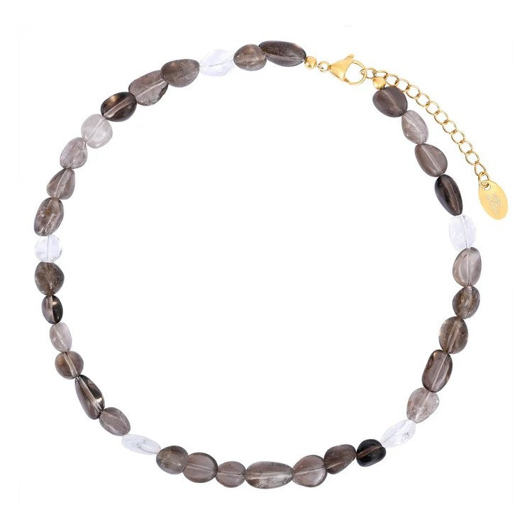 Necklace with oval, dark and clear beads, gold clasp and chain.