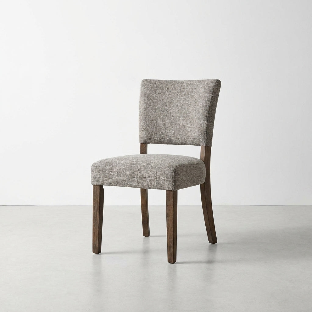 Gray upholstered chair with wooden legs on a white background.