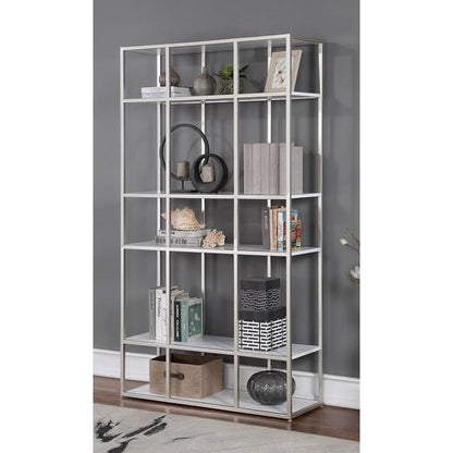 Modern bookshelf with decor and books on a gray wall.