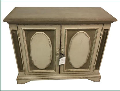 Vintage wooden cabinet with a distressed finish and ornate detailing.