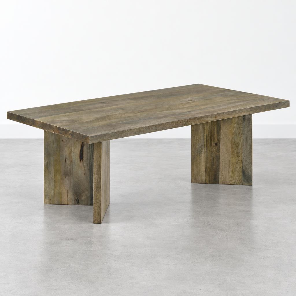 Wooden table with thick legs on a light gray floor.