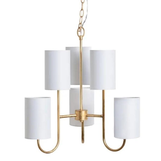 Gold chandelier with five white cylindrical shades.