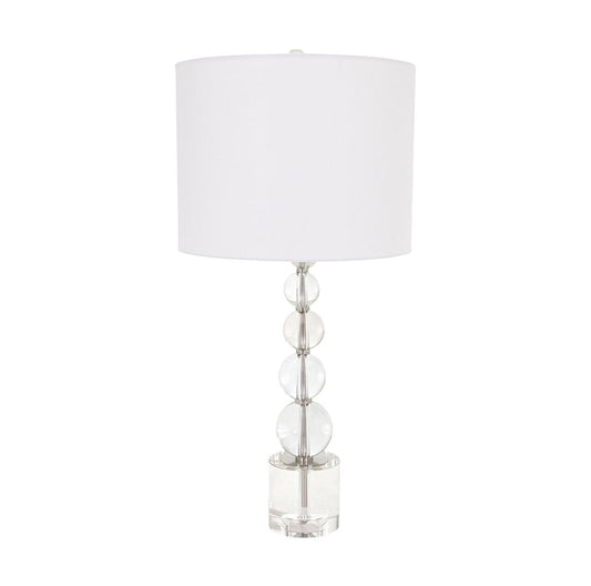 Modern lamp with stacked glass spheres and a white drum shade.