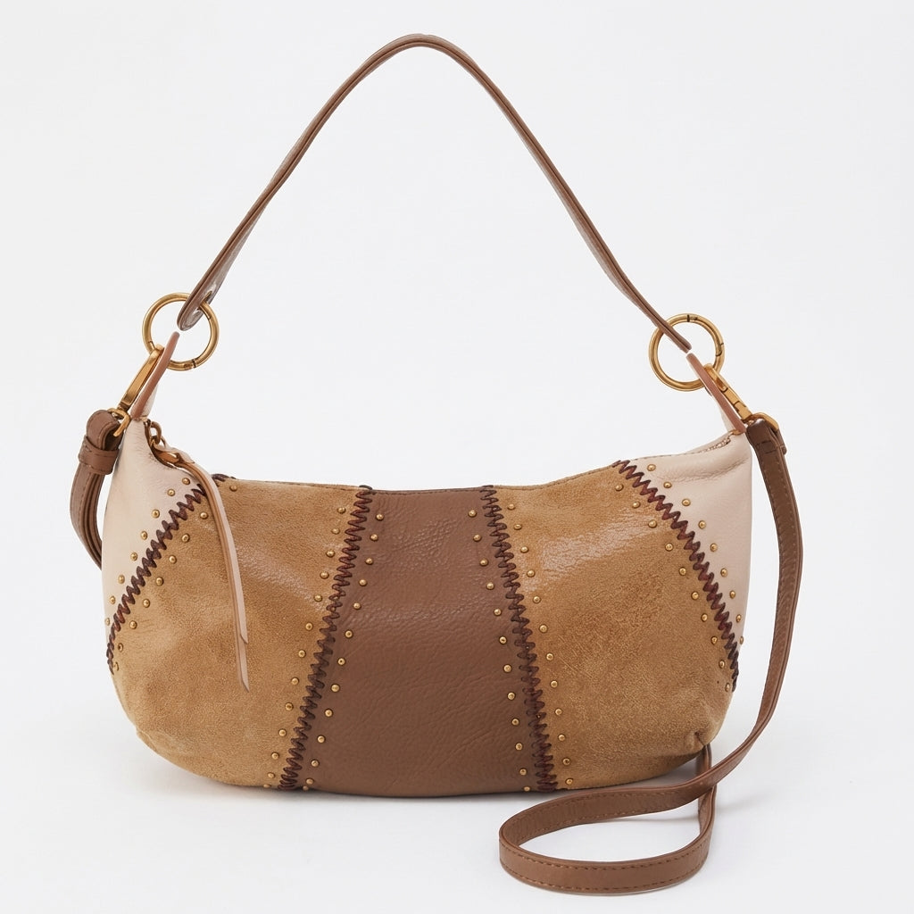 Brown patchwork handbag with gold studs and shoulder strap.