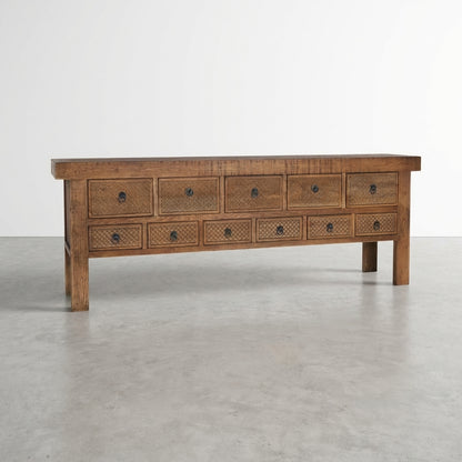 Wooden drawer console with multiple drawers in a rustic style.