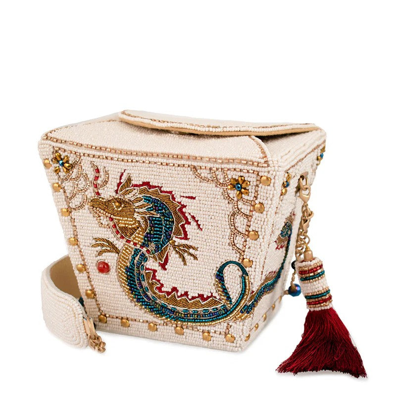 Intricately beaded bag with dragon design and red tassel.