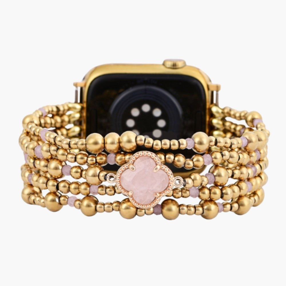 Gold beaded watch band with pink accents and flower detail.