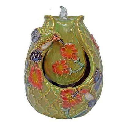 Ceramic candle holder with colorful floral and bird designs.