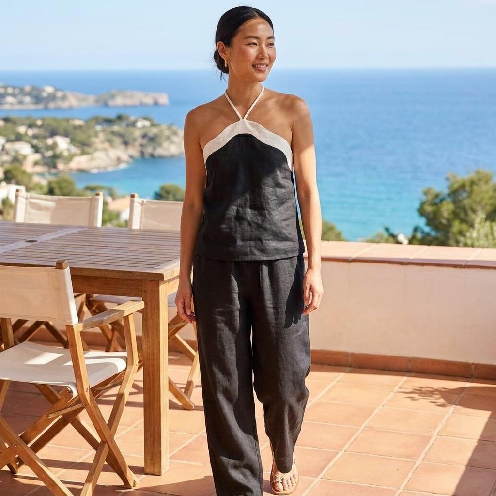 Woman smiling on a terrace overlooking the sea.
