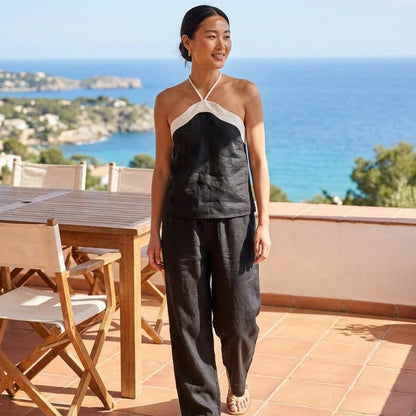 Woman smiling on a terrace overlooking the sea.