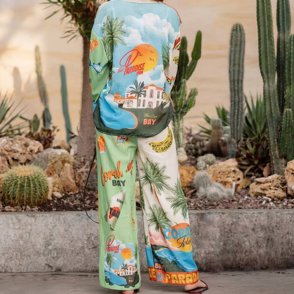 Person in colorful tropical outfit standing in a cactus garden.