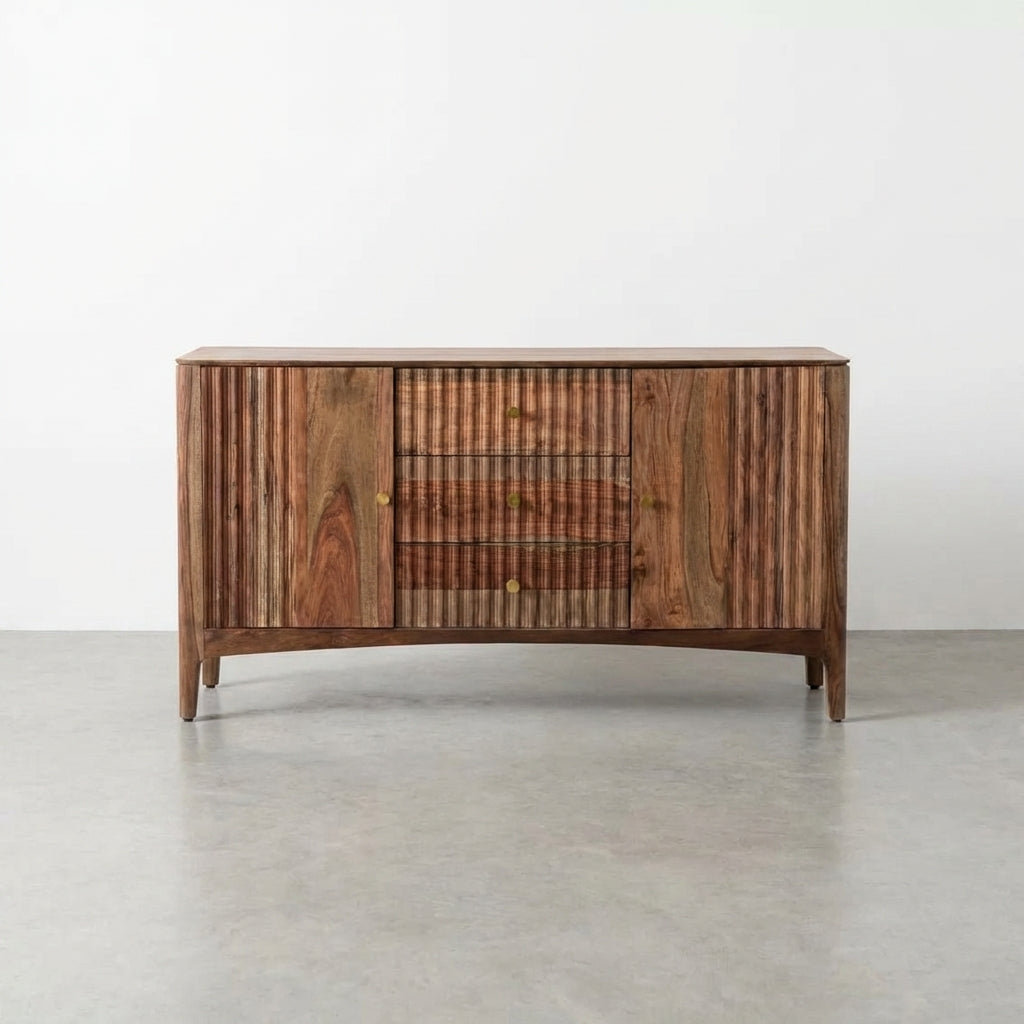 Wooden sideboard with fluted design and brass knobs on a neutral background.