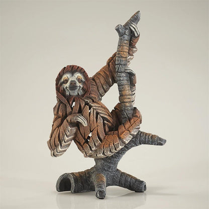 Abstract sculpture of a sloth hanging from a branch.