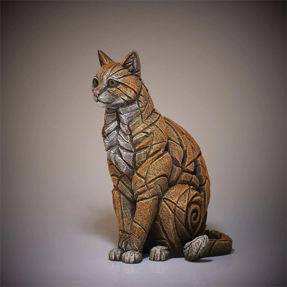 Sculpted cat figurine made of metallic pieces.