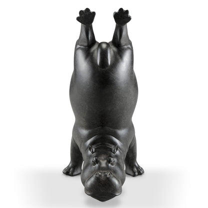 Upturned hippo statue performing a handstand.