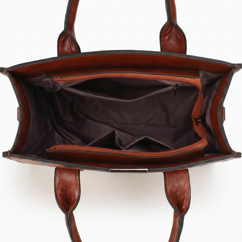 Open brown leather handbag with empty compartments.