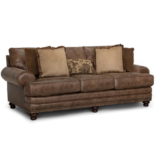 Brown leather sofa with ornate cushions and studded detailing.