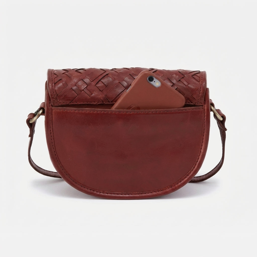 Red leather crossbody bag with phone in front pocket.