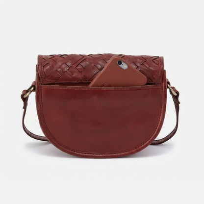 Red leather crossbody bag with phone in front pocket.